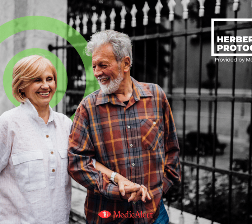 A man and woman are out walking together down the street and smiling